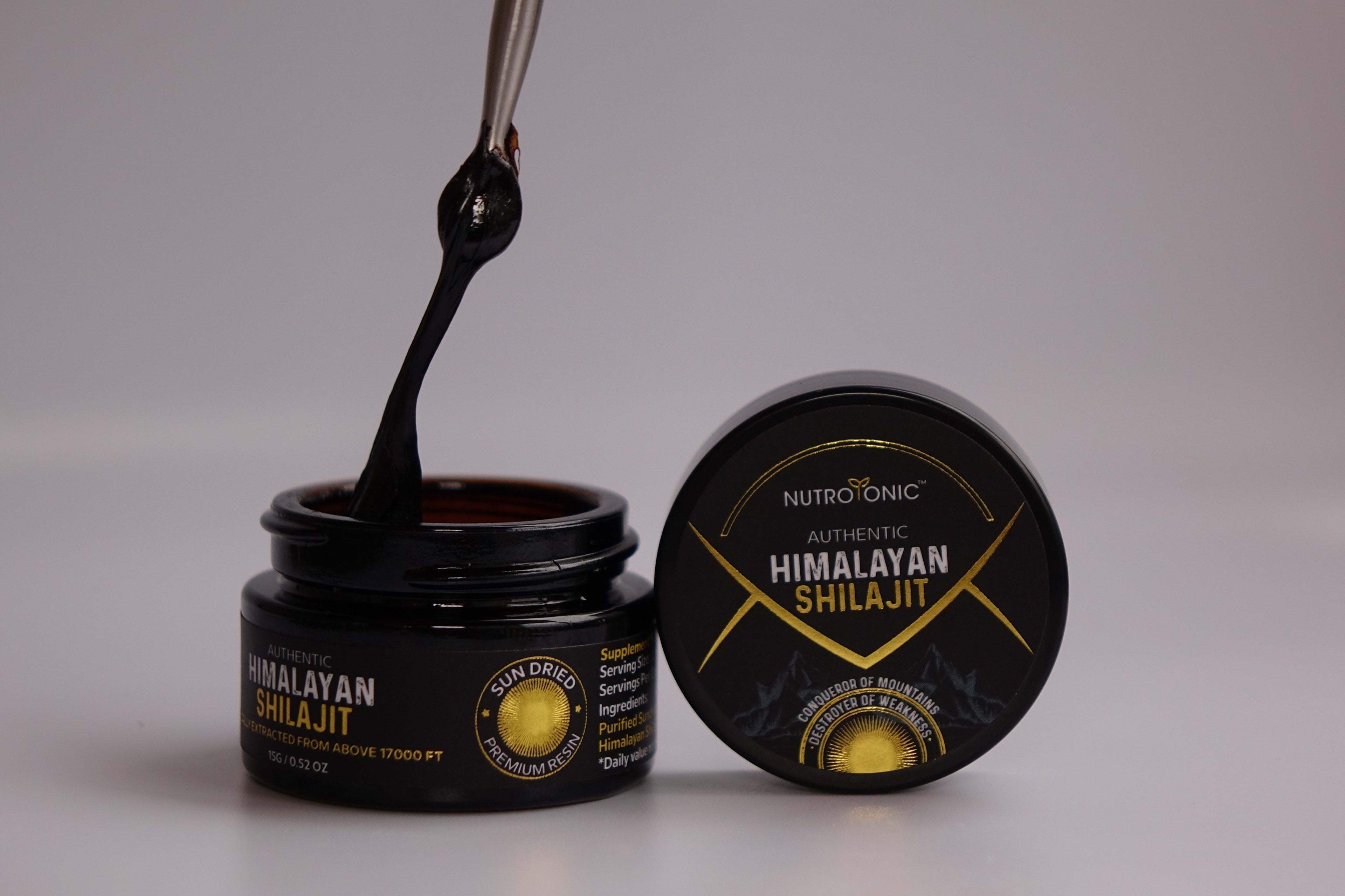 NutroTonic Authentic Himalayan Shilajit resin being extracted from a jar.