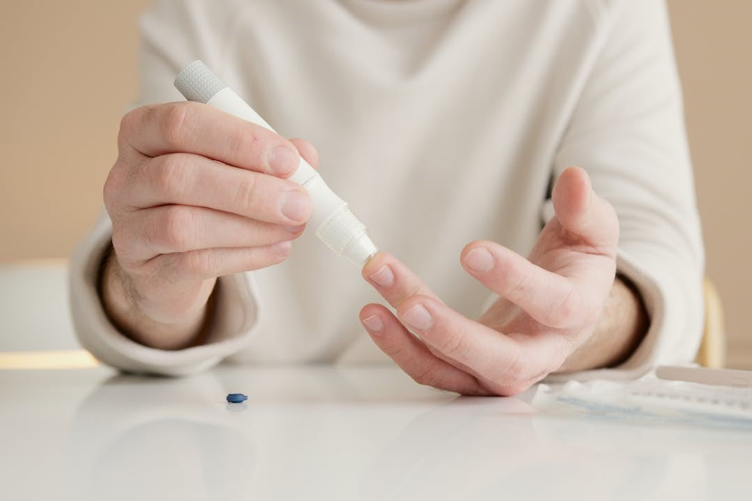 A person using a glucose meter to check blood sugar levels.
