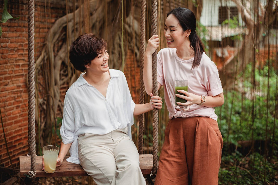 Two women enjoying refreshing drinks outdoors.